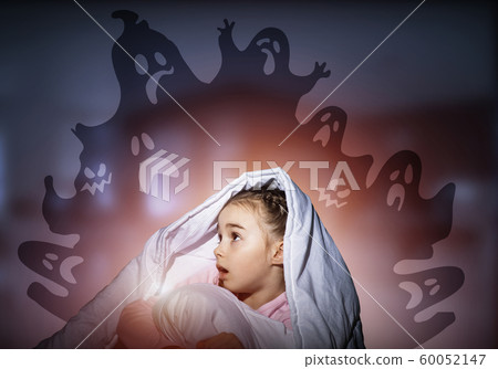 Excited girl hiding under blanket Excited girl hiding under blanket 60052147