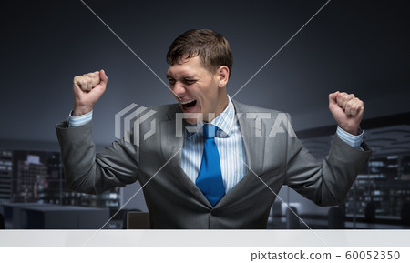 Happy excited businessman celebrating victory 60052350
