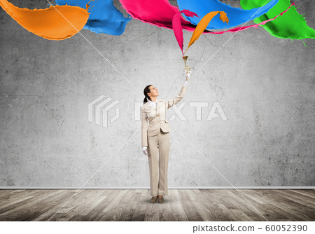 Woman holds trumpet brass instrument over head 60052390