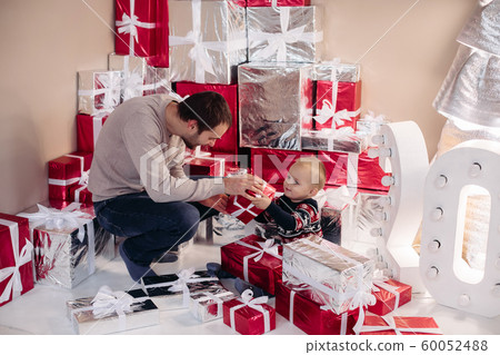 Loving dad giving present to his son. Loving dad giving present to his son. 60052488