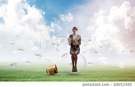 Young woman holding open book 60052489