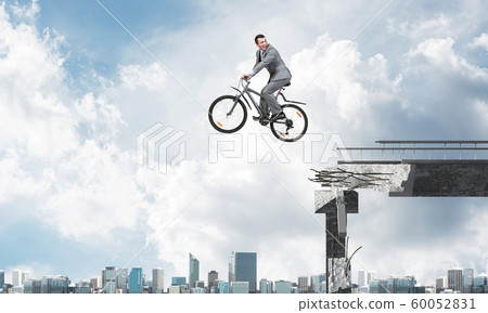 Businessman commuting to work by bike Businessman commuting to work by bike 60052831