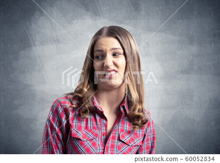 Displeased young woman looks squeamishly 60052834