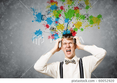 Stressful redhead student keeps hands on head Stressful redhead student keeps hands on head 60052920