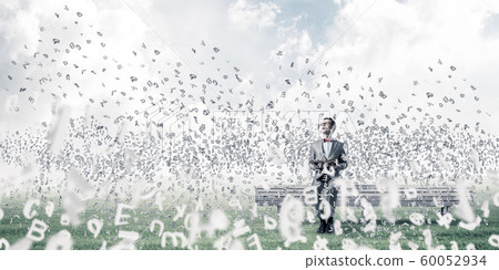 Young businessman or student studying the science and symbols fly around Young businessman or student studying the science and symbols fly around 60052934