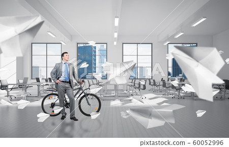 Young man wearing business suit with bike 60052996