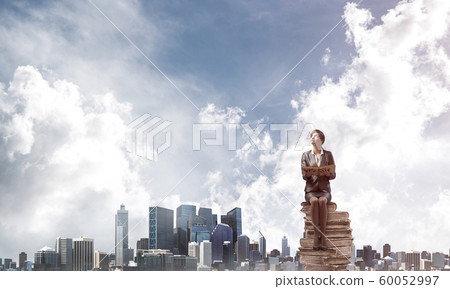 Smiling woman holding open book 60052997