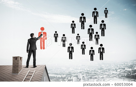 Businessman standing with back on house brick roof and drawing. 60053004