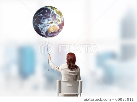 Woman holding by rope earth globe Woman holding by rope earth globe 60053011