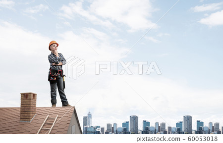Pensive female construction worker in hardhat Pensive female construction worker in hardhat 60053018