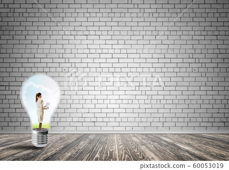Businesswoman trapped in bulb Businesswoman trapped in bulb 60053019