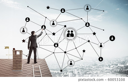 Businessman on house roof presenting networking and connection c Businessman on house roof presenting networking and connection c 60053108