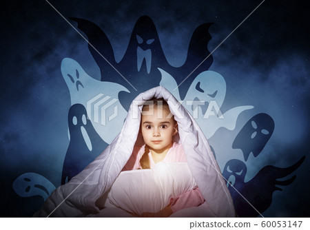 Scared girl with pillow hiding under blanket Scared girl with pillow hiding under blanket 60053147