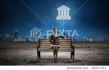 Young woman with open book on wooden bench 60053167