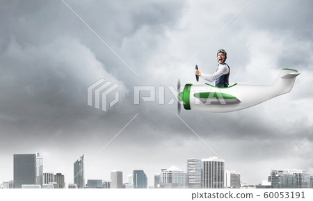 Businessman in aviator hat and goggles Businessman in aviator hat and goggles 60053191