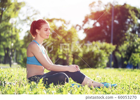 Beautiful smiling girl in sportswear relax in park Beautiful smiling girl in sportswear relax in park 60053270