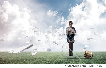 Young woman holding open book 60053366