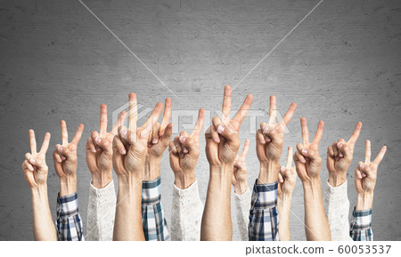Row of man hands showing victory gesture Row of man hands showing victory gesture 60053537