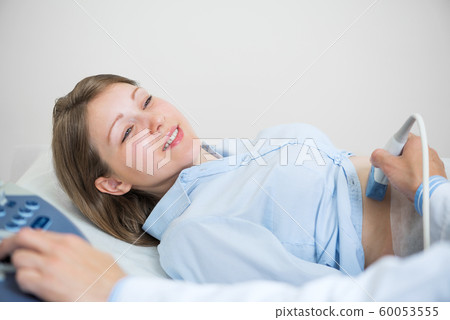 Doctor doing ultrasound screening checkup 60053555