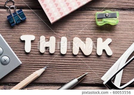 Think word on wooden table and office stationary around Think word on wooden table and office stationary around 60053556