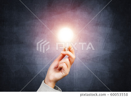 Human hand with glowing incandescent lamp Human hand with glowing incandescent lamp 60053558