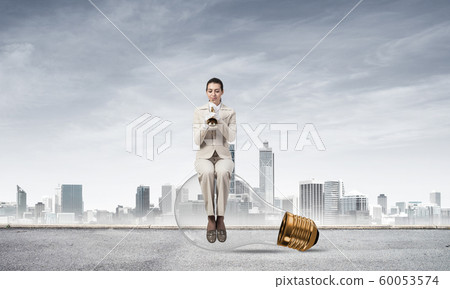 Attractive woman playing trumpet brass Attractive woman playing trumpet brass 60053574