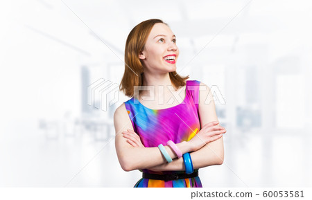 Smiling woman standing with folded arms 60053581