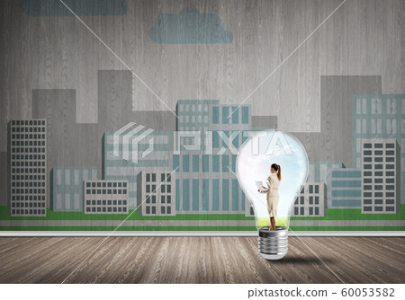 Businesswoman trapped in bulb Businesswoman trapped in bulb 60053582