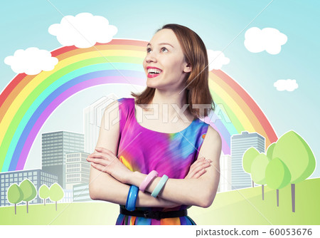 Smiling woman standing with folded arms Smiling woman standing with folded arms 60053676