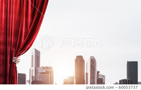 Modern business cityscape behind curtain opened by businessman hand Modern business cityscape behind curtain opened by businessman hand 60053737