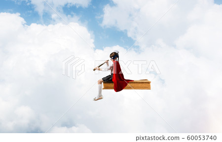 Girl power concept with cute kid guardian against cloudscape background Girl power concept with cute kid guardian against cloudscape background 60053740