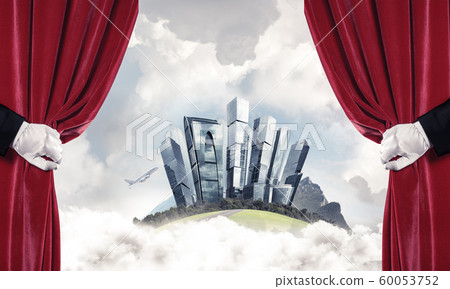 Modern cityscape behind drapery curtain and hand opening it Modern cityscape behind drapery curtain and hand opening it 60053752