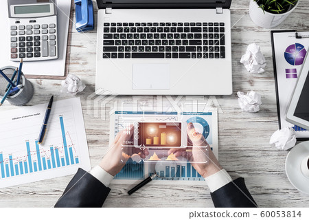 Businessman using smartphone at office desk Businessman using smartphone at office desk 60053814