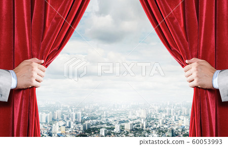 Modern business cityscape behind curtain opened by businessman hand Modern business cityscape behind curtain opened by businessman hand 60053993