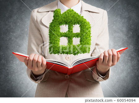 Real estate agent showing green plant Real estate agent showing green plant 60054094