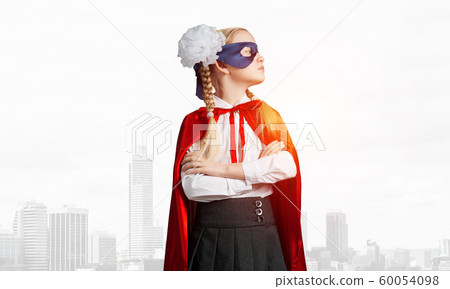 Girl power concept with cute kid guardian against cityscape background Girl power concept with cute kid guardian against cityscape background 60054098
