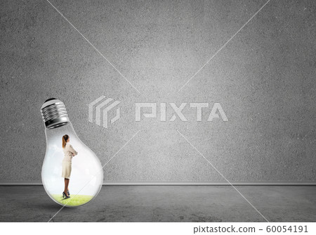 Businesswoman trapped in bulb Businesswoman trapped in bulb 60054191
