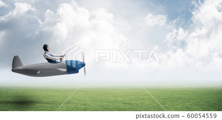 Happy aviator driving small propeller plane 60054559