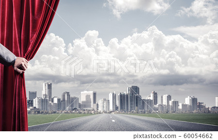 Asphalt road behind red curtain and hand holding it Asphalt road behind red curtain and hand holding it 60054662