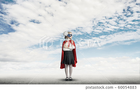 Girl power concept with cute kid guardian against cloudscape background . Mixed media 60054883