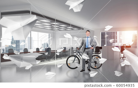 Smiling man in business suit standing with bike Smiling man in business suit standing with bike 60054935