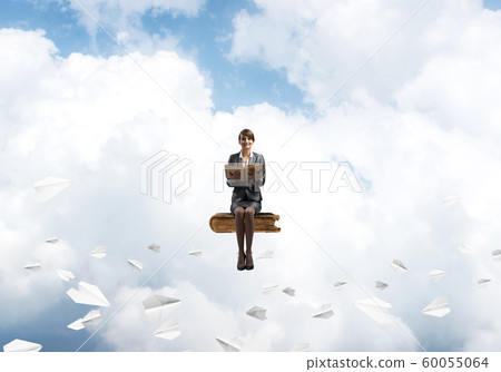 Smiling woman holding open book Smiling woman holding open book 60055064