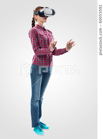Young woman wearing VR goggles Young woman wearing VR goggles 60055092