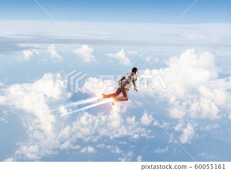 Businessman in suit and aviator hat flying in sky Businessman in suit and aviator hat flying in sky 60055161