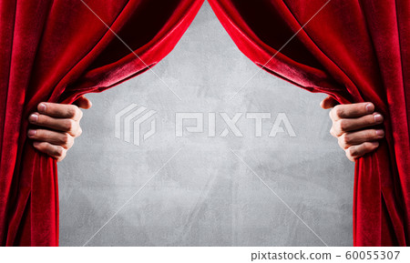 Concrete wall behind drapery curtain and hand opening it Concrete wall behind drapery curtain and hand opening it 60055307