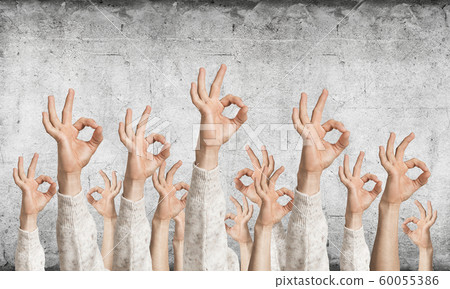 Row of man hands in white sweater showing okay 60055386