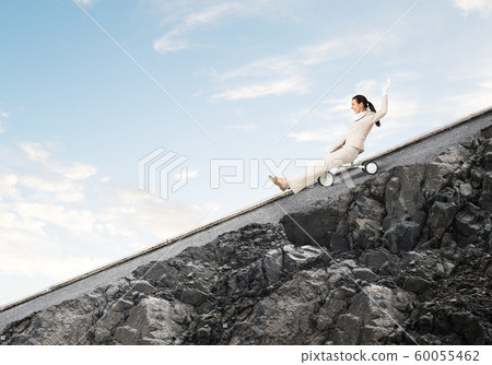 Beautiful happy woman riding downhill Beautiful happy woman riding downhill 60055462