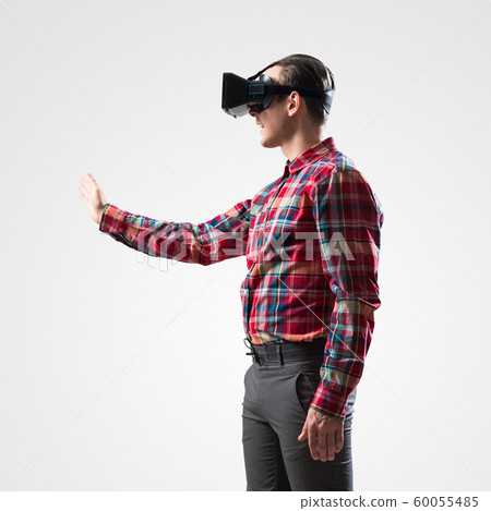 Guy in mask experiencing virtual reality as new entertainment device Guy in mask experiencing virtual reality as new entertainment device 60055485