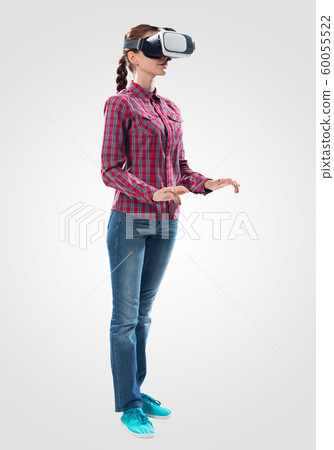 Young woman wearing VR goggles Young woman wearing VR goggles 60055522