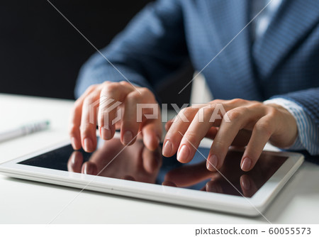 Male hands typing on digital tablet touch screen Male hands typing on digital tablet touch screen 60055573